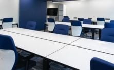 Modern office space with white tables and blue chairs