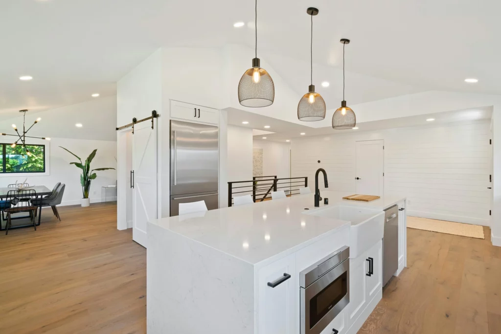 Modern kitchen with white countertops and pendant lights